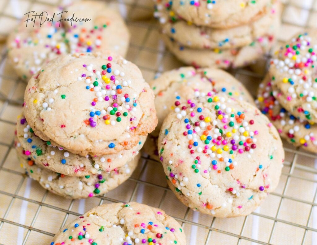 confetti cookies stacked on cooling rack