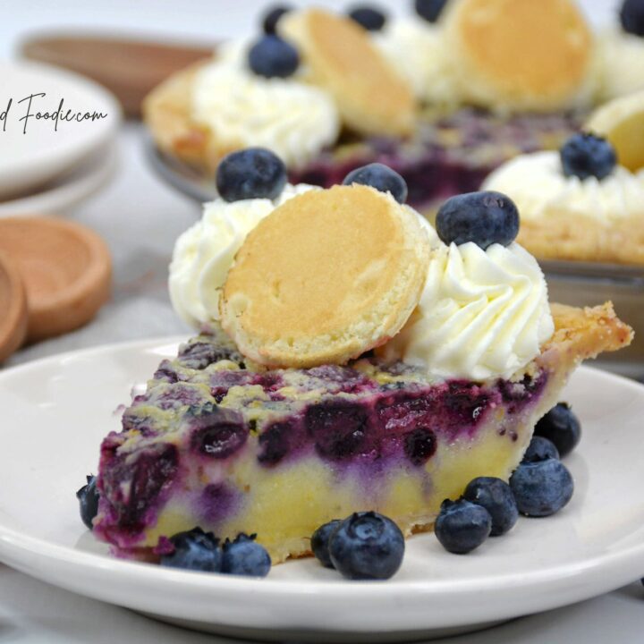 blueberry pancake pie with berries plates wooden spoons