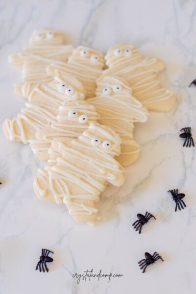 mummy sugar cookies with spiders on marble table