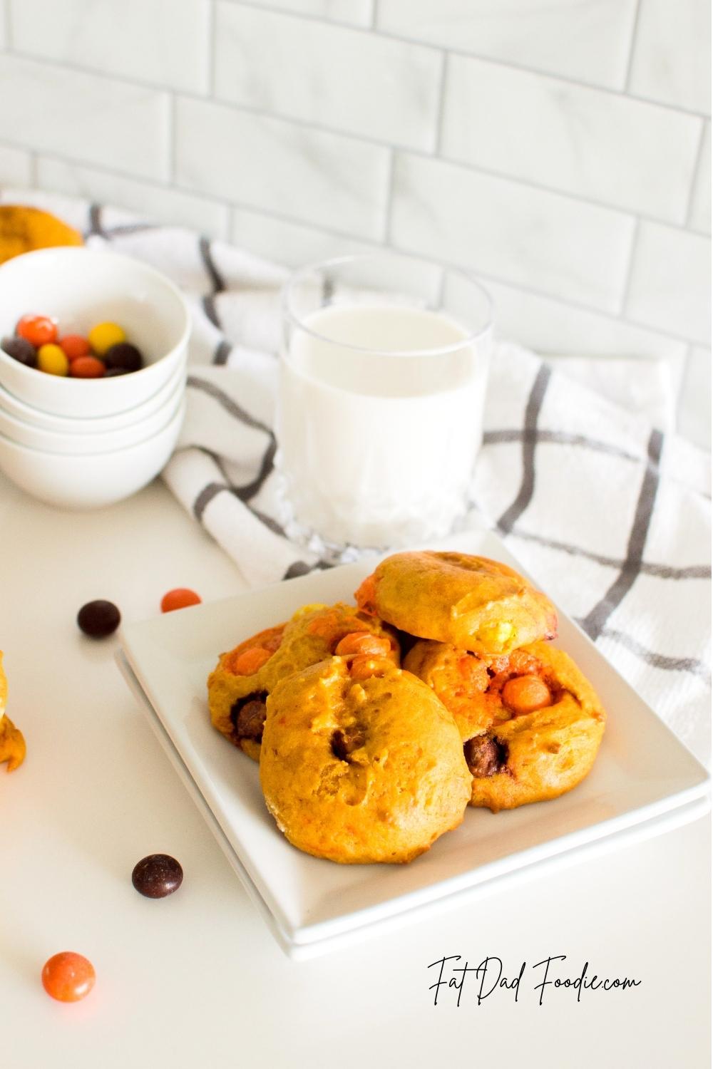 reeses pieces pumpkin cookies with a glass of milk