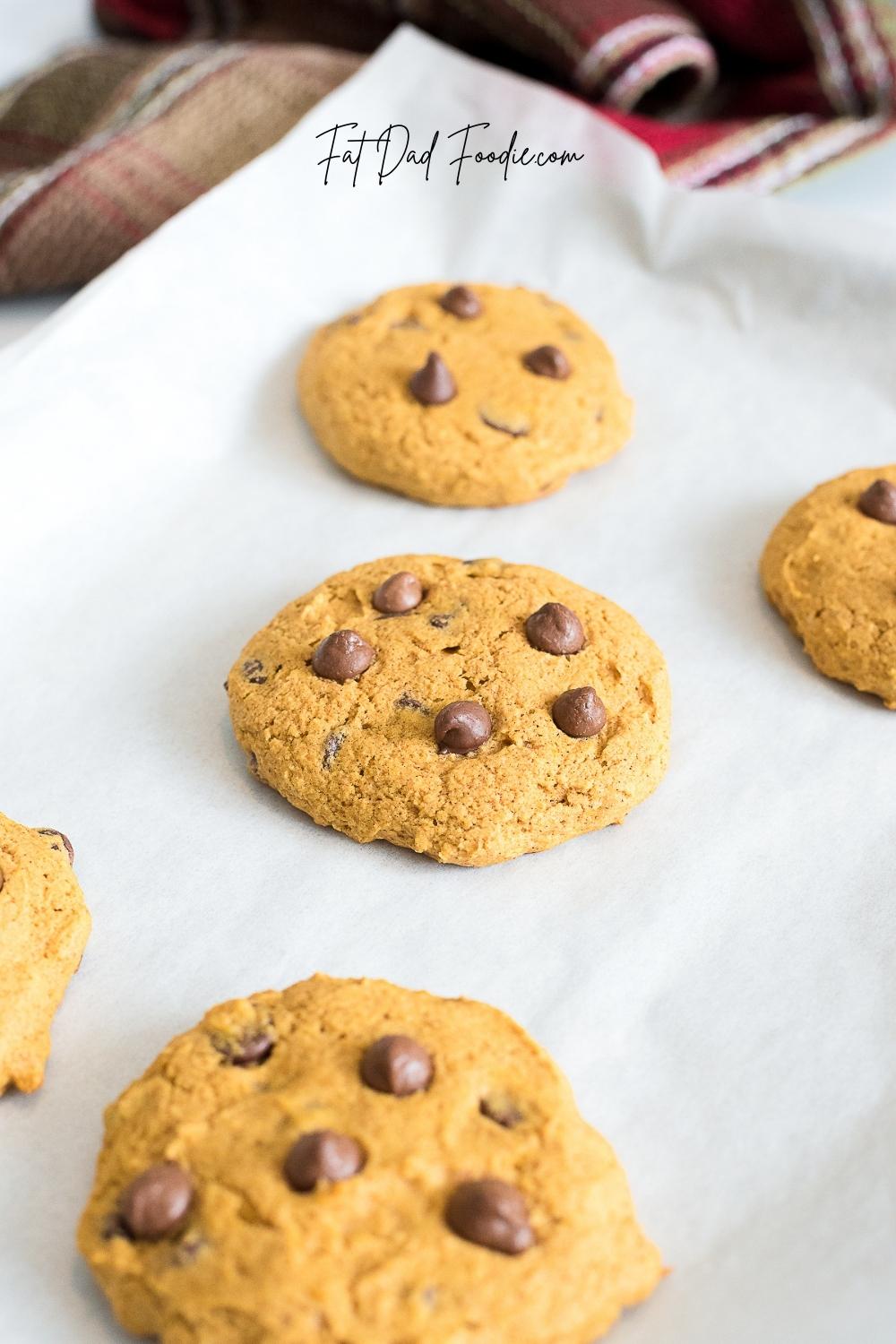 crumbl pumpkin chocolate chip cookies on parchment paper