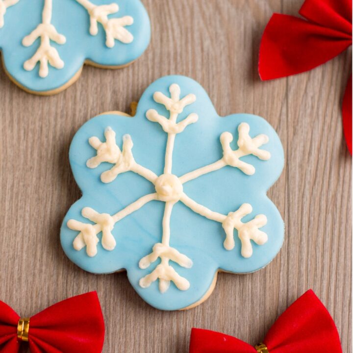 snowflake cookie recipe on wood with bows