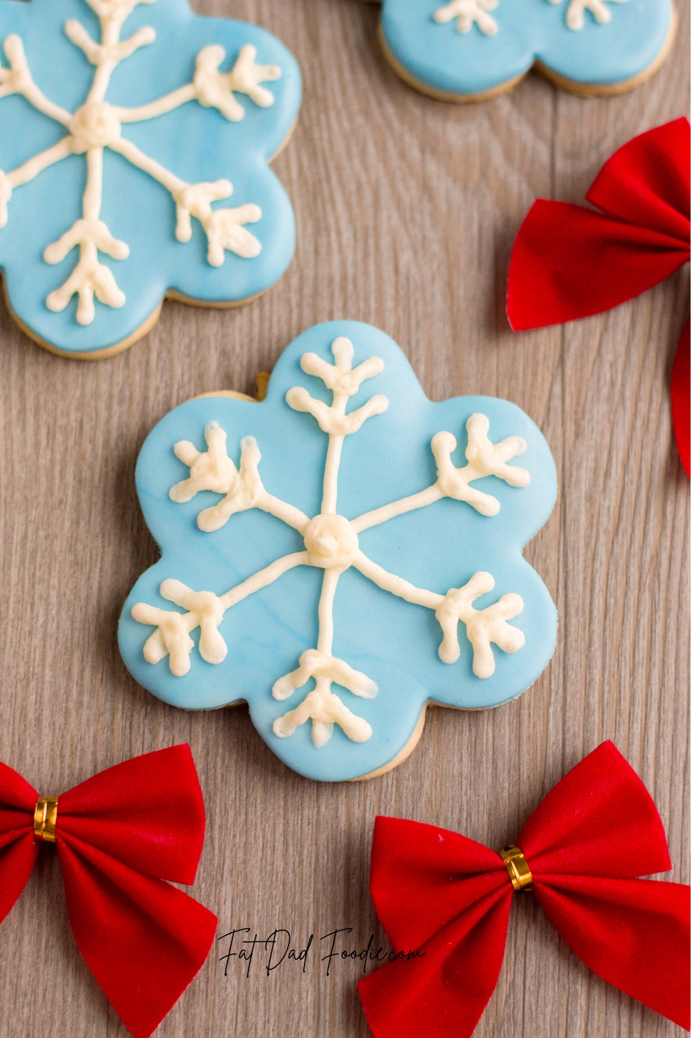 snowflake cookie recipe on wood with bows