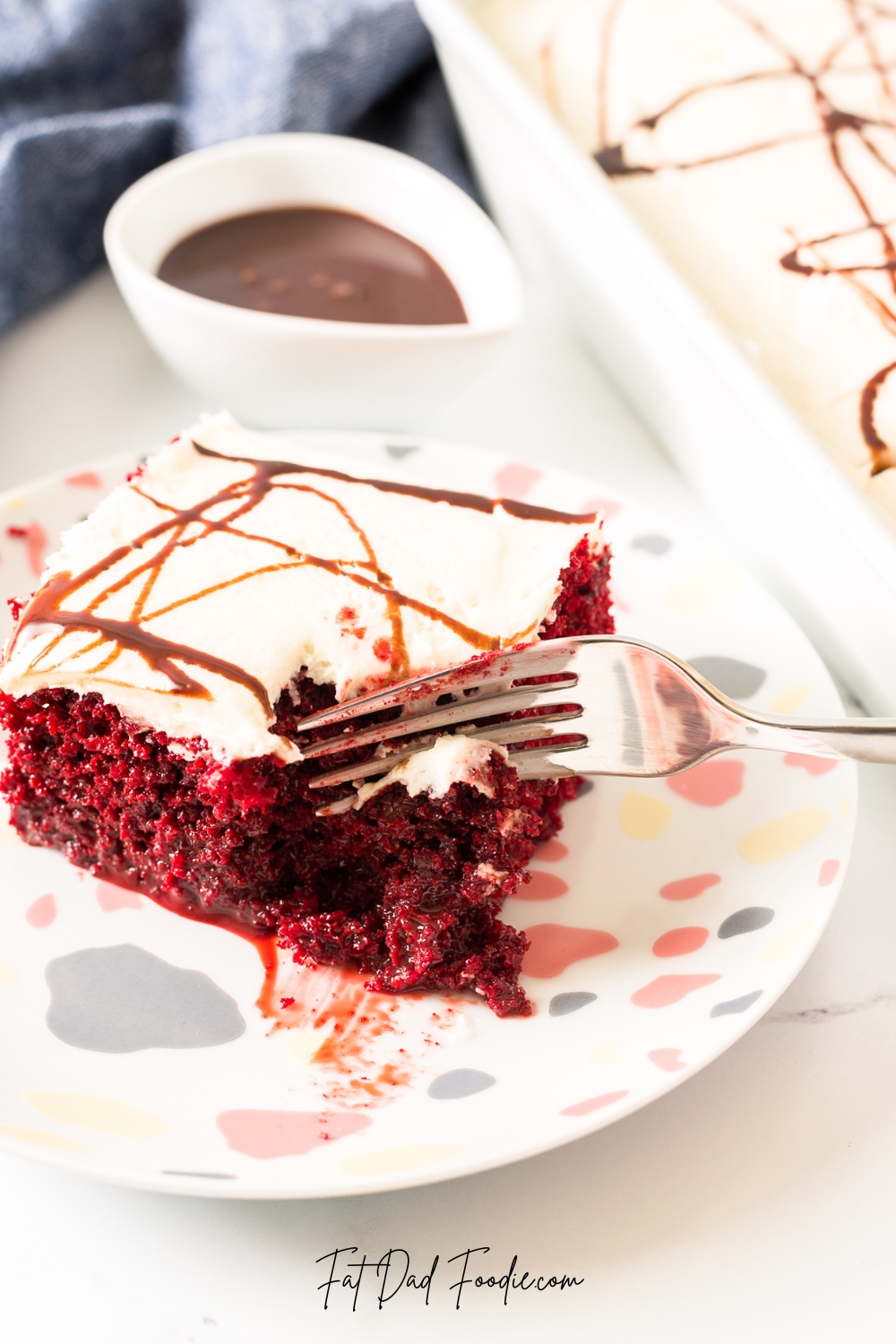 red velvet poke cake with chocolate sauce